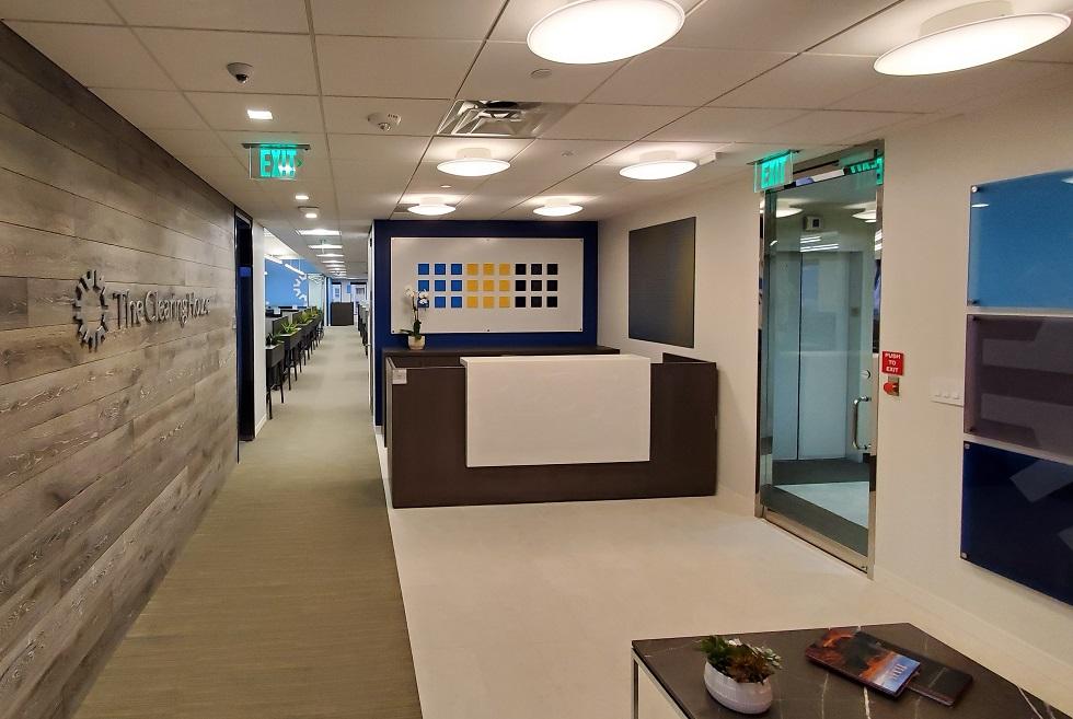 Reception area features branding wall and signage